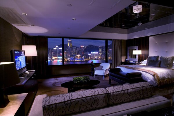 Stylish interior of a room with a view of the night city from the window