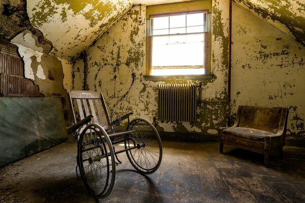 An abandoned room with a wheelchair