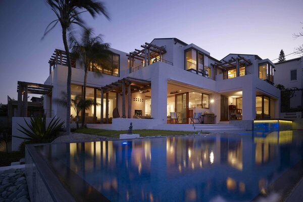 Villa with pool palm trees evening