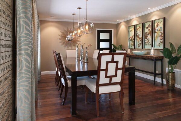 Stylish dining room with Art Nouveau paintings and chandelier