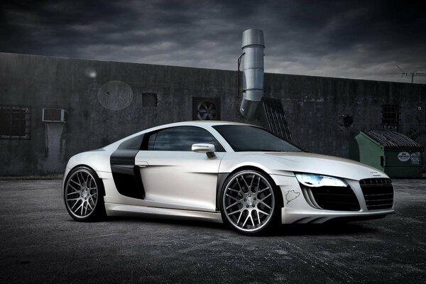 White supercar on a gray sky background