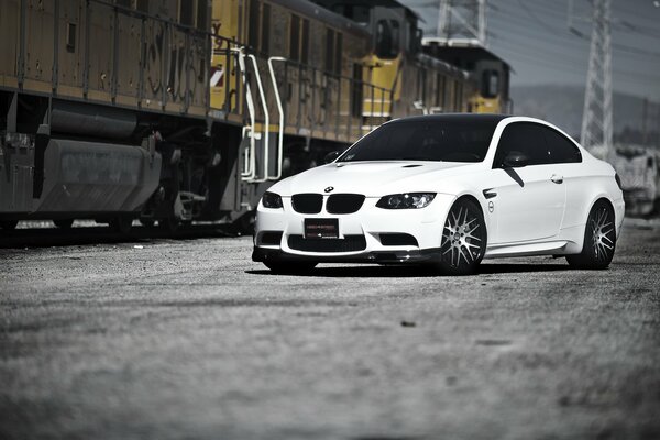 White BMW on the background of a power line