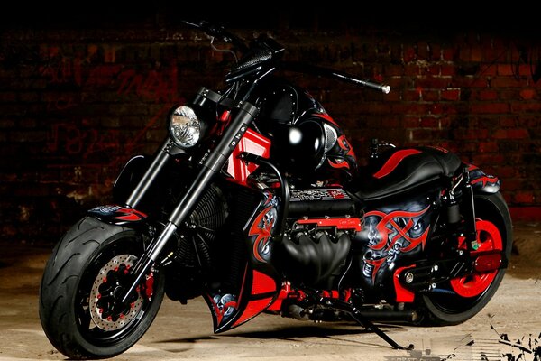 Black and red motorcycle on a brick wall background
