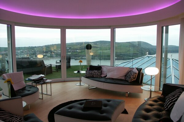 Interior with two-level ceilings with RGB lighting and panoramic glazing