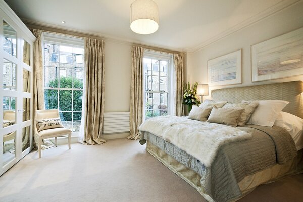 Bedroom in a spacious room with large windows