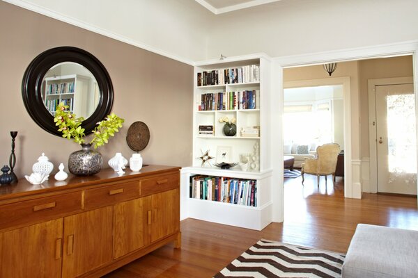 One of the rooms of a residential cottage. Stylishly equipped with a wooden storage cabinet and a bookcase