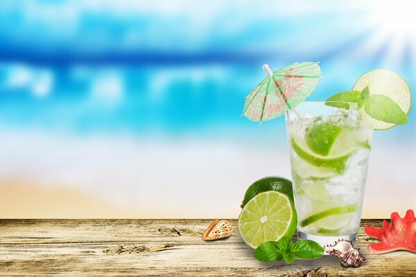 Refreshing ice mojito with cocktail umbrella and lime