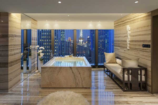 Jacuzzi by the window with a view of the skyscrapers