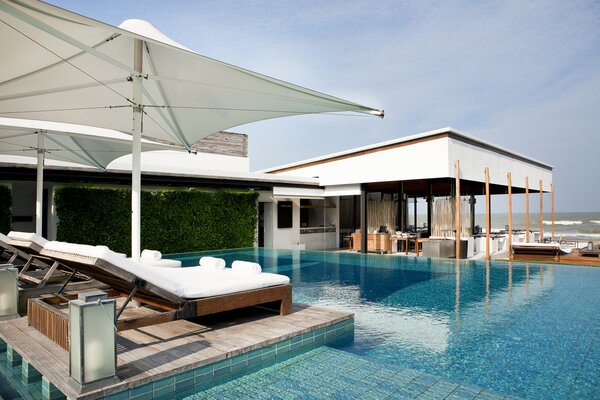 An exotic vacation by the ocean with a relaxing pool at the hotel