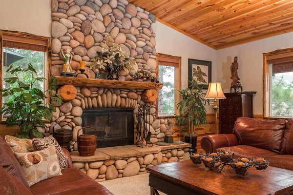 A large fireplace lined with stones. Stylish solution