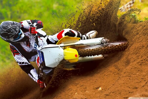 A motorcyclist in a race rides at high speed