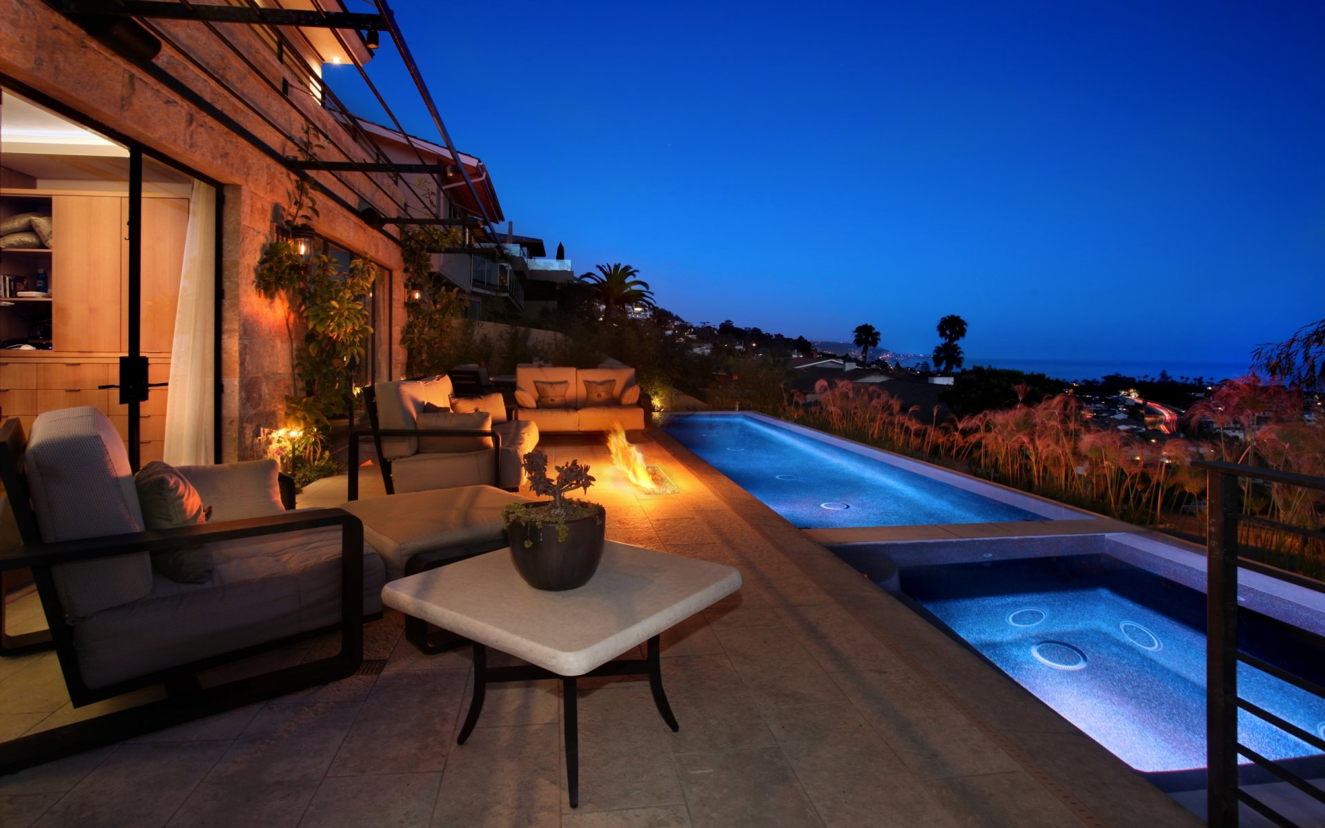 casa piscina jacuzzi muebles sillones sofá fuego paisaje noche