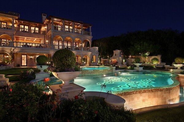 Ein Haus in der Nacht und ein beleuchteter Pool