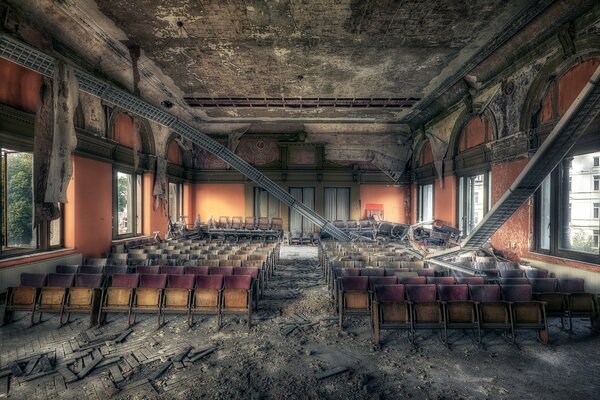 A gloomy ruined hall with chairs