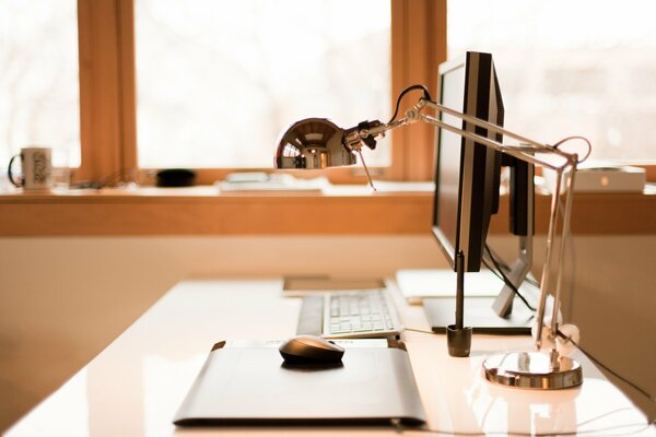 Workplace with computer and lamp