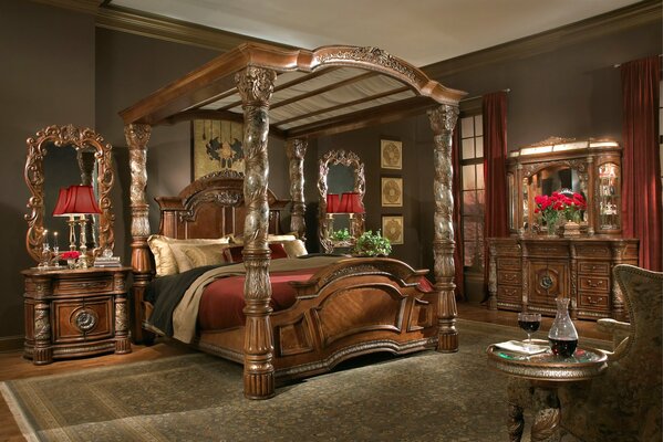 A huge bed and massive wooden furniture in the bedroom