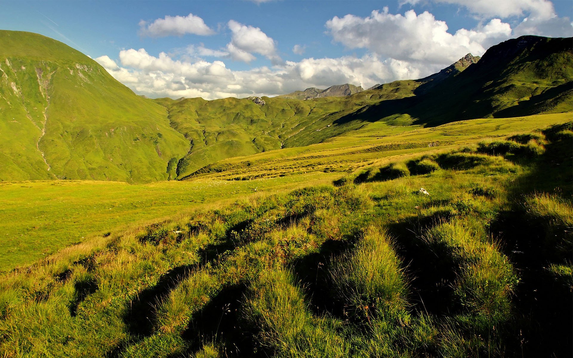 clouds grass hills green