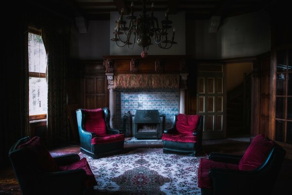 Mansion guest room with fireplace armchairs large chandelier in the middle