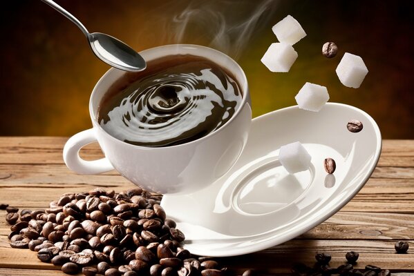 Kaffee und Körner mit Zuckerwürfeln in einem weißen Glas und einer Untertasse