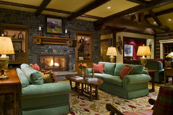 Cozy room with soft green sofas and fireplace