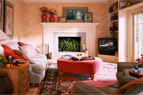 A room with a chest of drawers, flowers and furniture