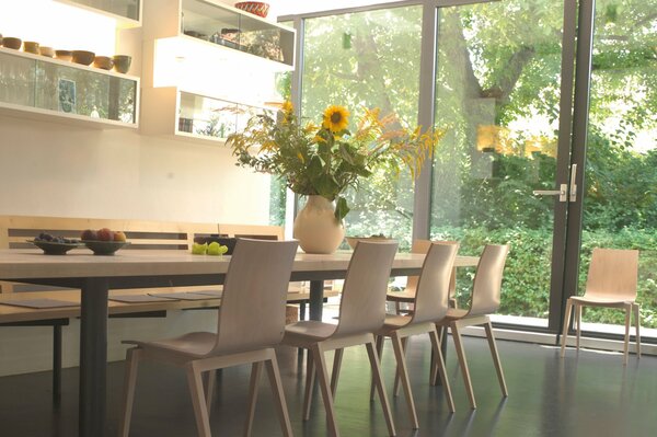 The interior of the dining room in the cottage in a calm white color