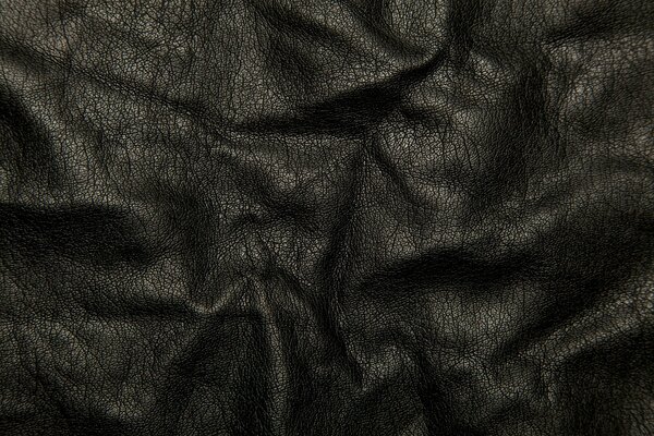 Pleats on black leather fabric