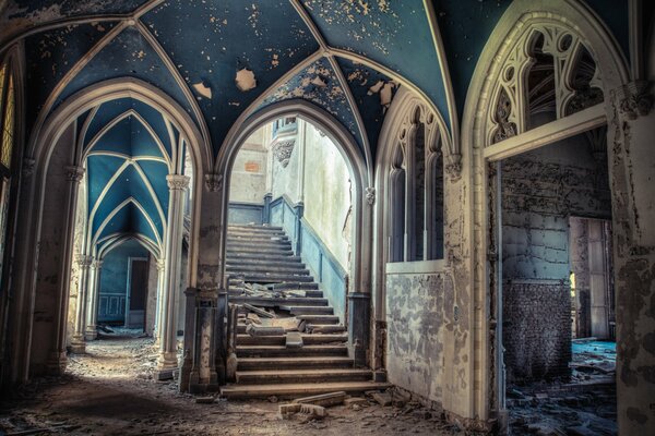 A ruined staircase in an abandoned mansion