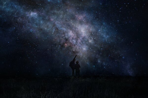 People on the background of the starry sky