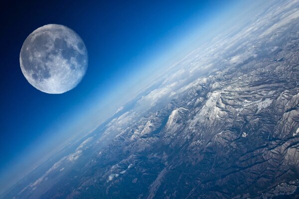 The surface of the planet Earth with a view of the Moon