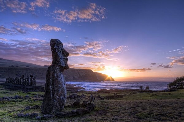 Idols on the island against the sunset