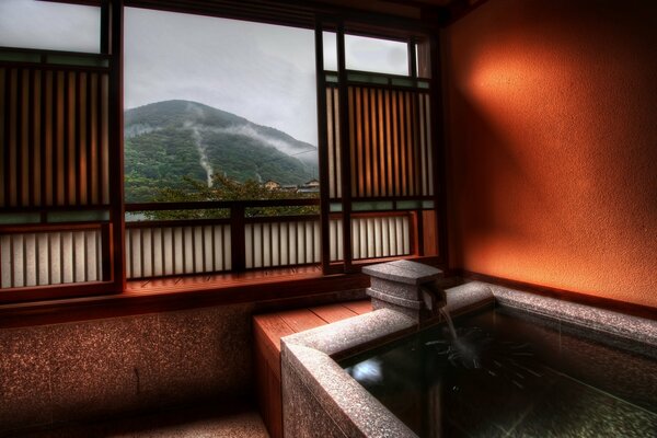 Bath in Japan with a view of the mountains from the window
