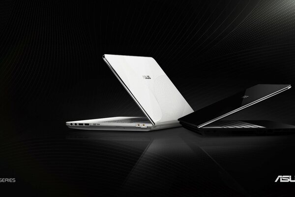 Two black and white Asus laptops