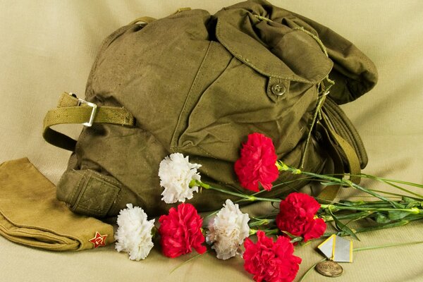 Defenders of the Fatherland. Military uniform with a medal and flowers