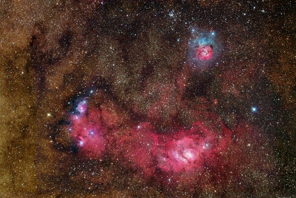 A huge cluster of stars and a red nebula