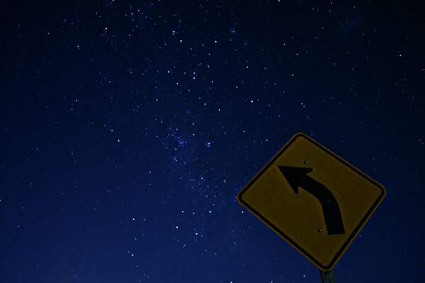 The arrow sign seems to point to the starry sky