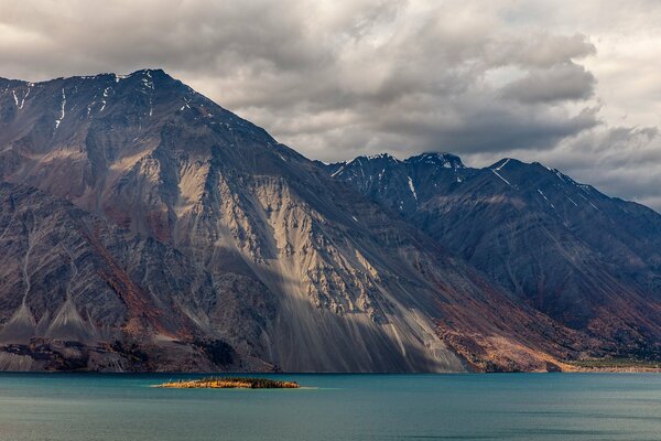 High crumbling rocks on the lake