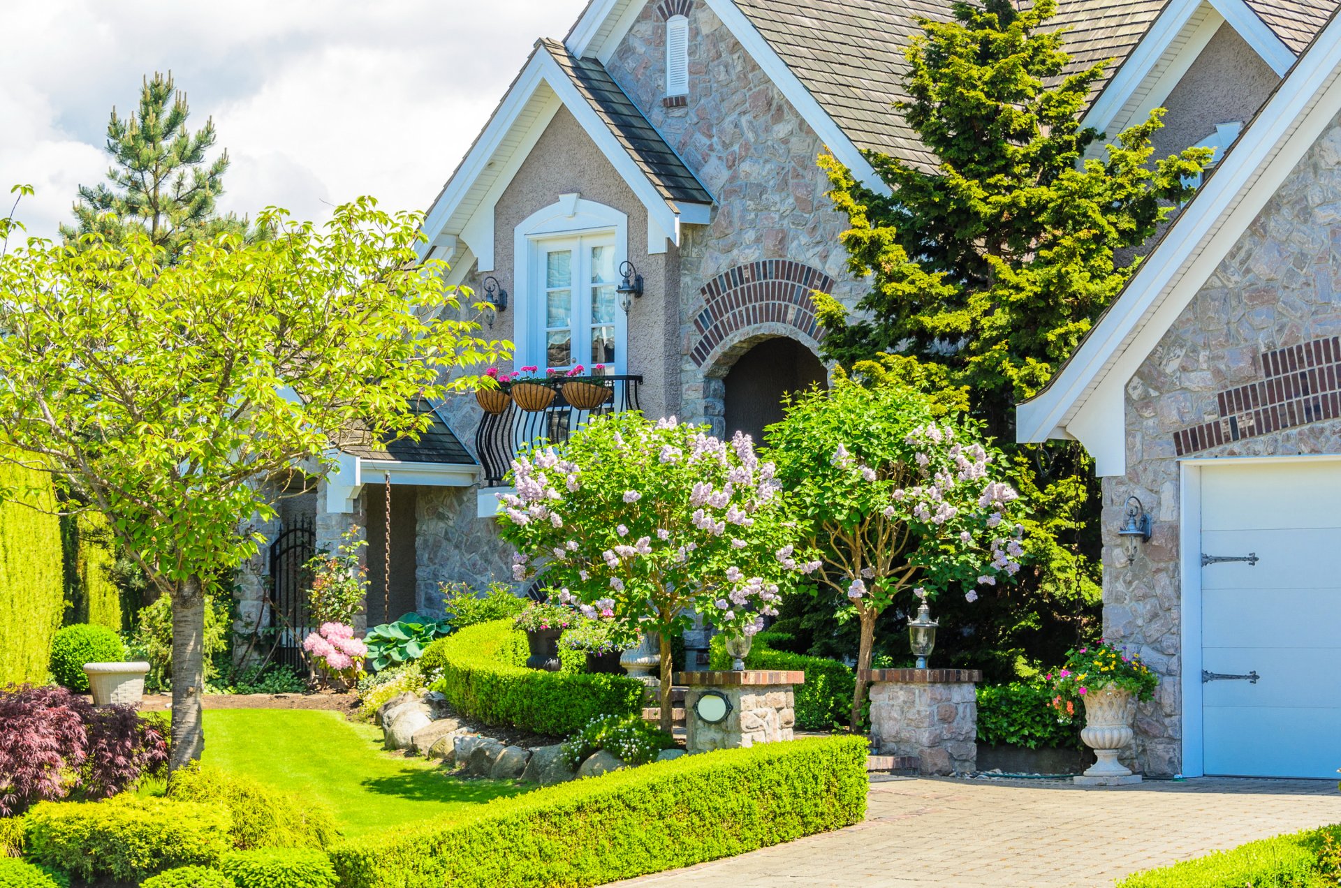 house mansion stones grass lawn bushes flowers greenery design