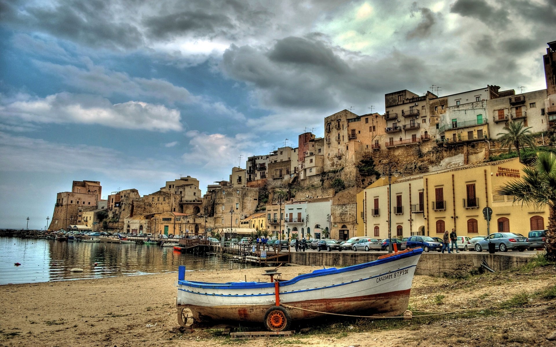 castellammare del golfo sicily italy castellammare del golfo harbor boat embankment buildings cars auto