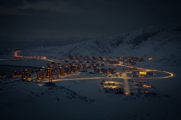 A small town in the snowy mountains at night