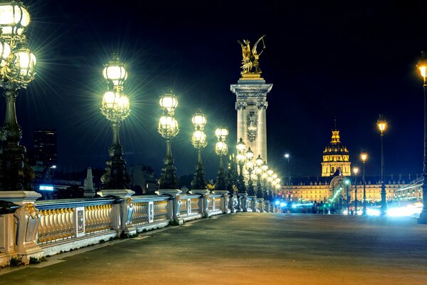Lanterns at night on the Alexander III Bridge in Paris