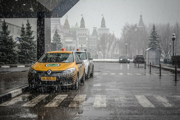 Taxi in the parking lot in the pouring rain