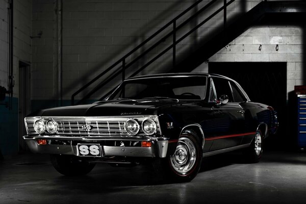 A black Chevrolet is in the garage