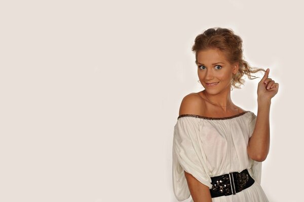 Kristina Asmus in a summer dress on a light background