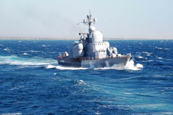 A beautiful warship against the background of sea waves