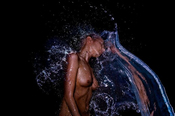 Beautiful nude girl under a stream of water