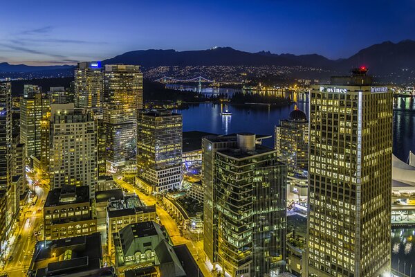 The lights of Vancouver at night. Skyscrapers in Canada