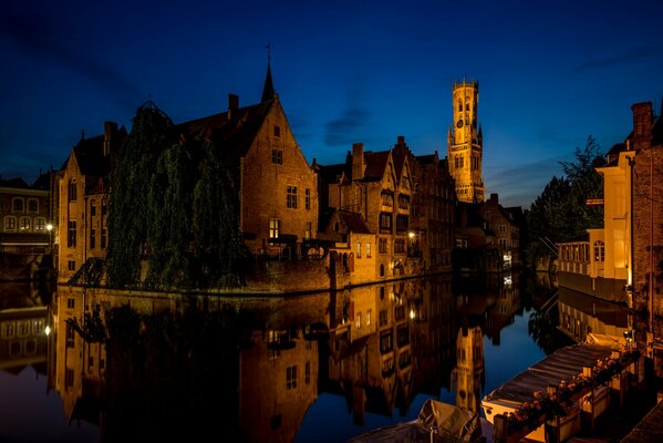 Houses at night are reflected in the water