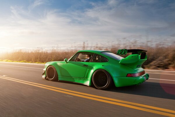 Green porshe car at high speed