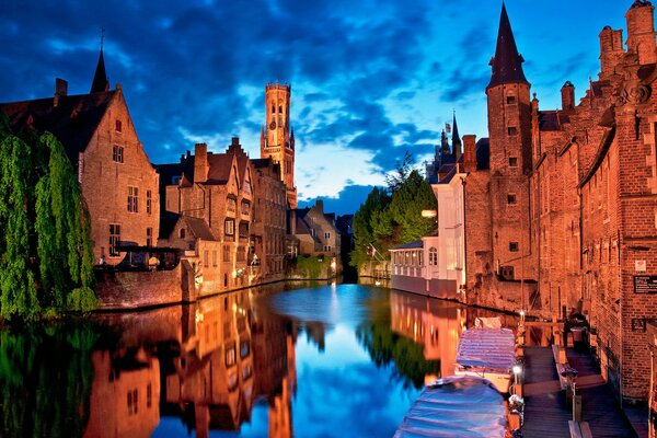 The landscape of the evening city is reflected in the water